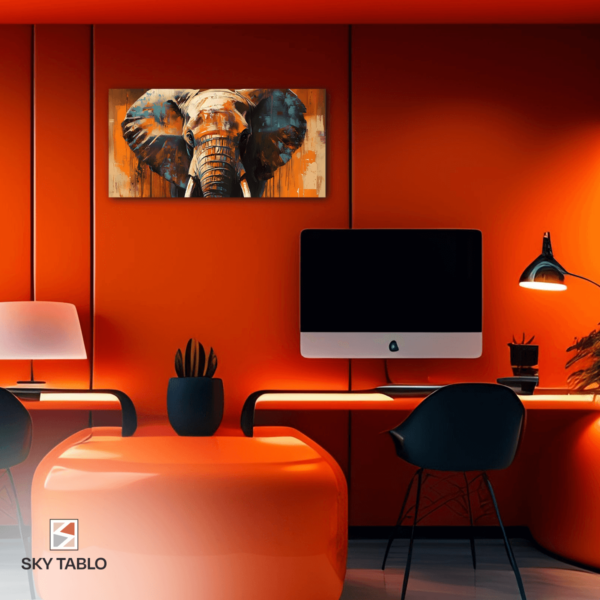 an orange room with a computer and a painting of an elephant